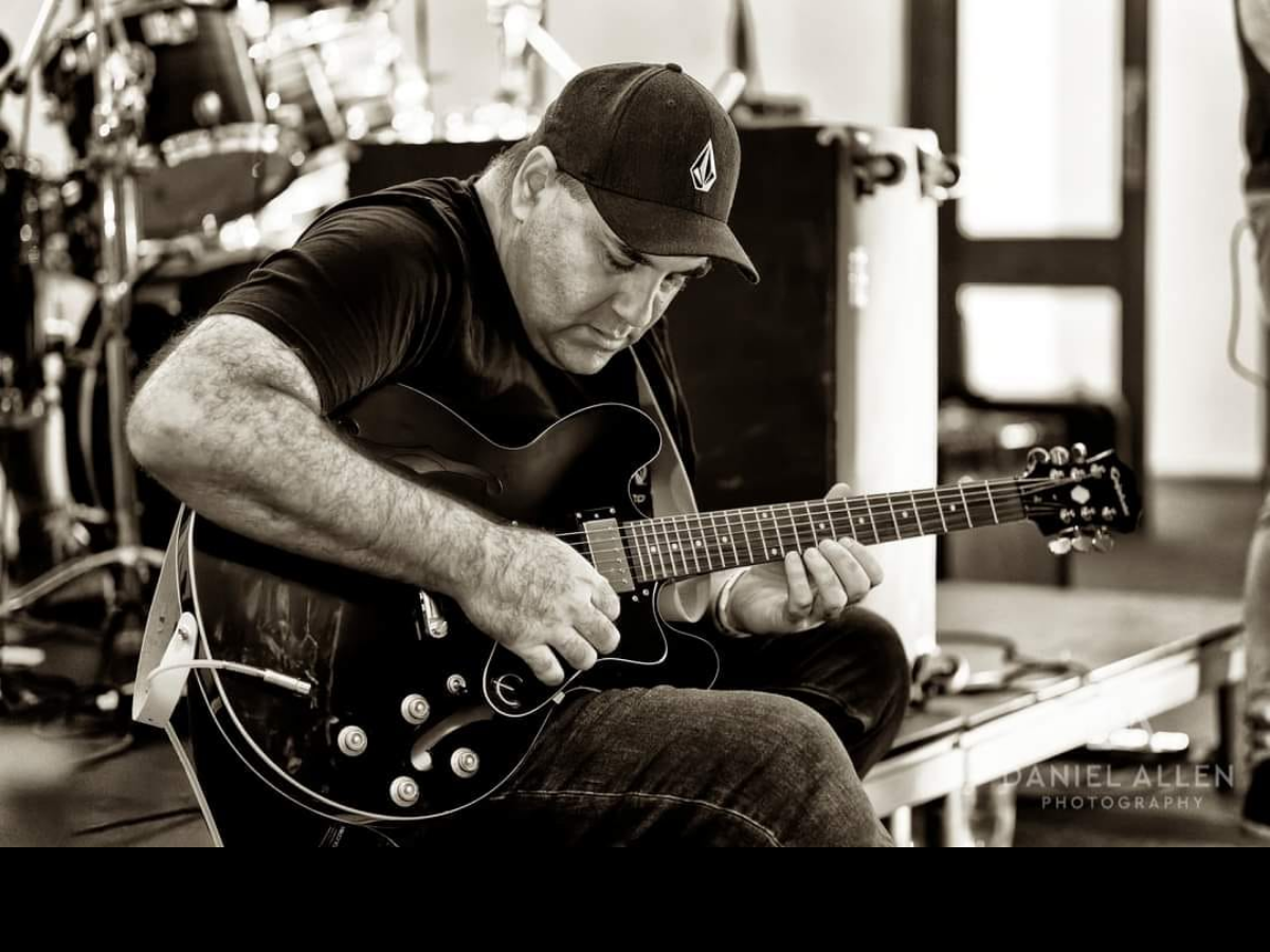 Last Chance Saloon guitarist performing